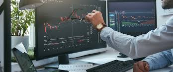 forex trader pointing on his desktop screen with Forex chart